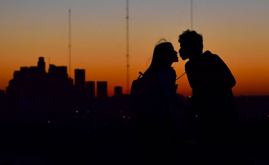 A couple kisses after sunset in Los Angeles on Feb. 10, 2022, as a winter heat wave hits California where abnormally high temperatures reached 20 degrees above normal. (FREDERIC J. BROWN/AFP via Getty Images)