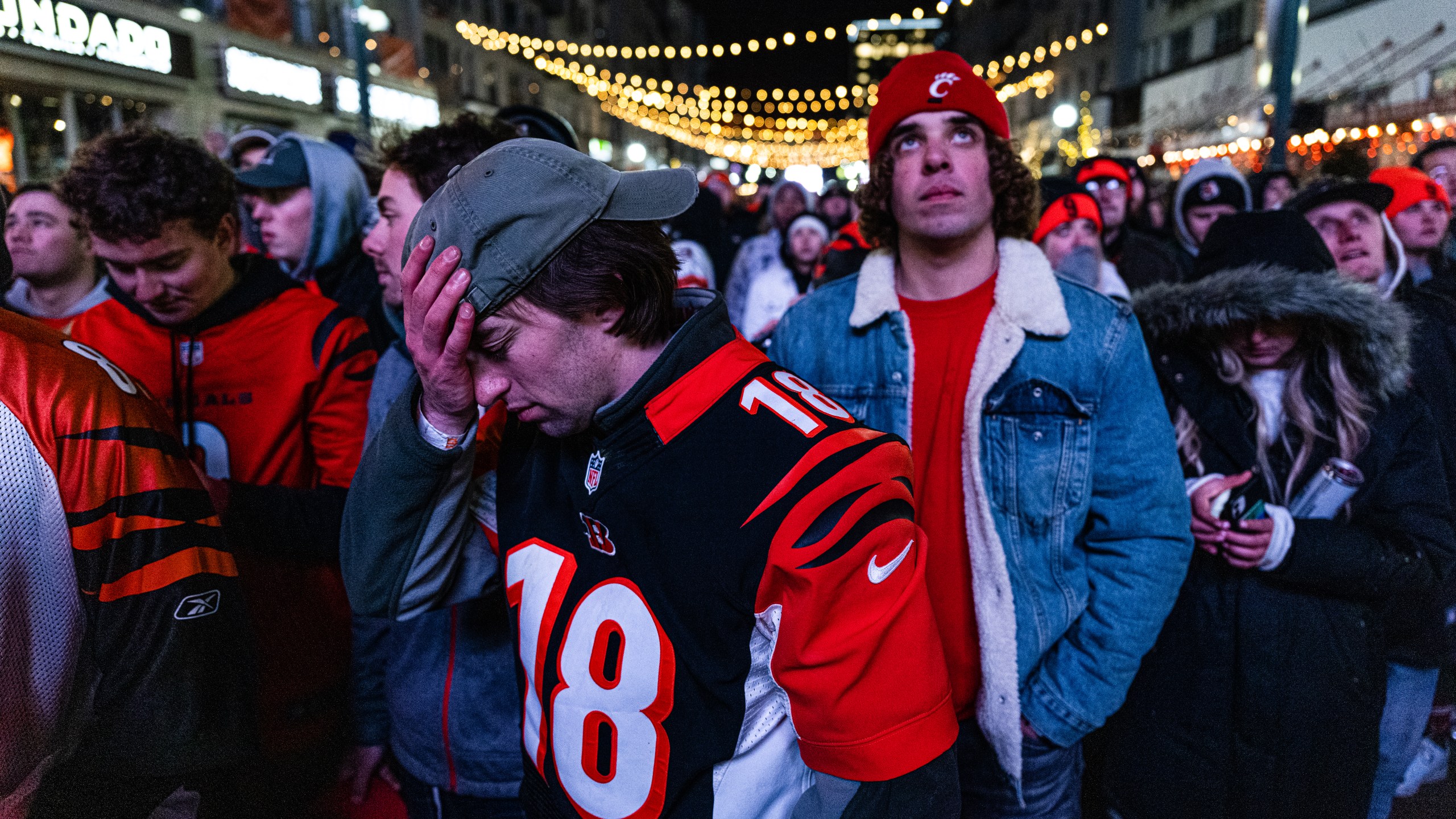 Bengals fans react to the final score of Super Bowl LVI being shown on a big screen at The Banks Riverfront Entertainment District in Cincinnati Fans gathered to watch the Cincinnati on Feb. 13, 2022. (Jon Cherry/Getty Images)