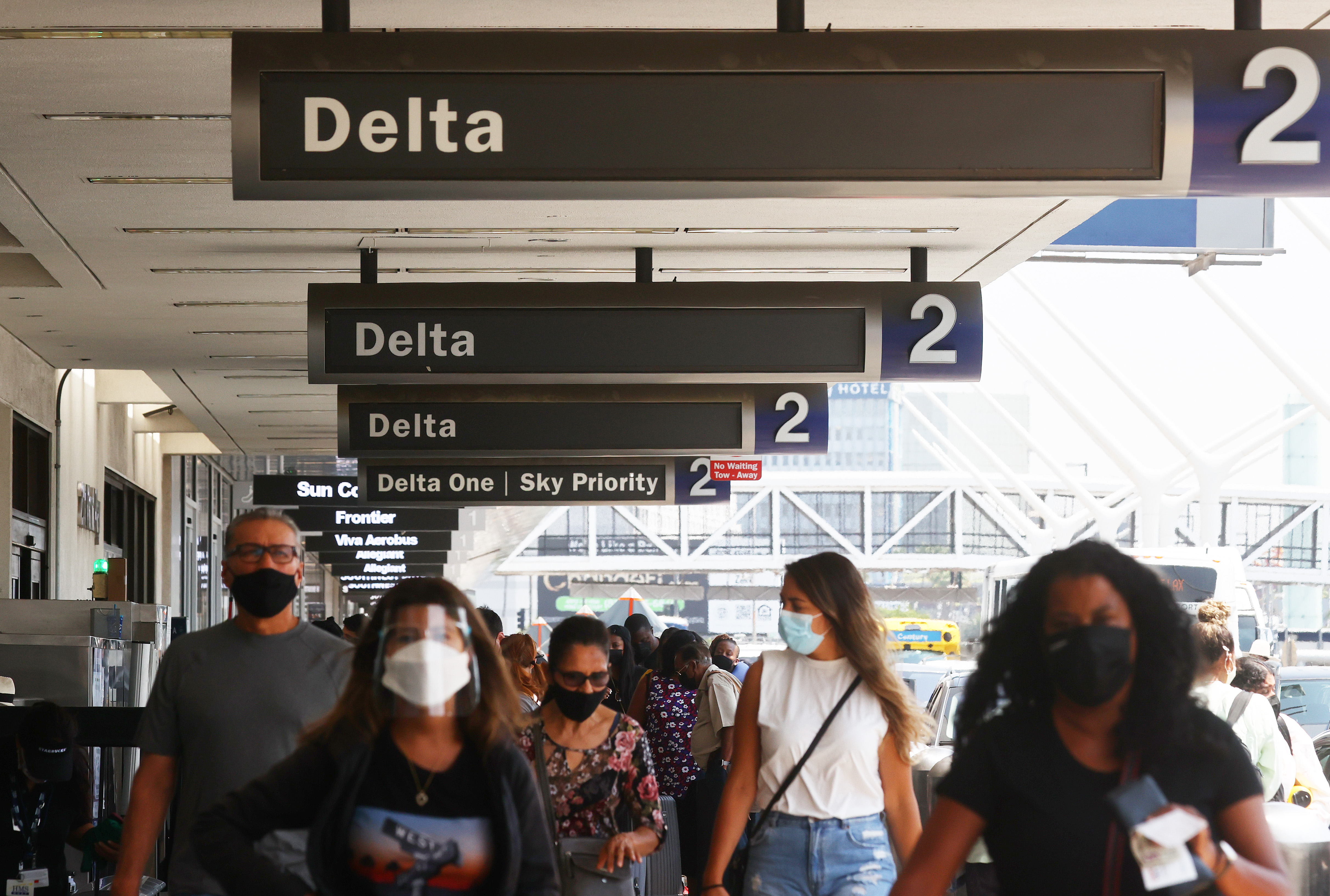 People gather outside the Delta Air Lines departures level at Los Angeles International Airport (LAX) on August 25, 2021 in Los Angeles, California. (Mario Tama/Getty Images)