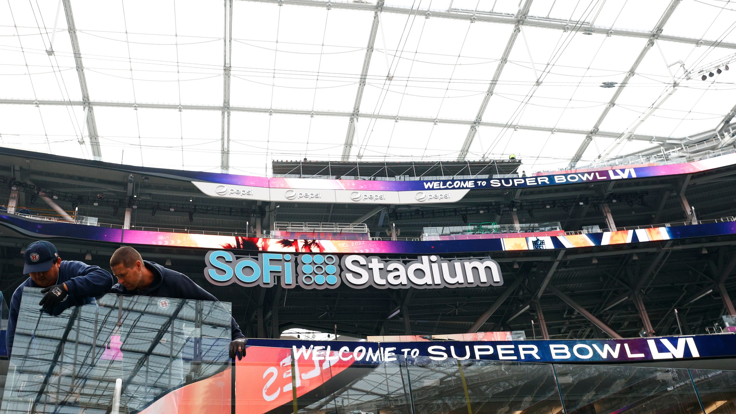 Workers install a glass partition in preparation for Super Bowl LVI at SoFi Stadium on Feb. 1, 2022 in Inglewood. (Ronald Martinez/Getty Images)