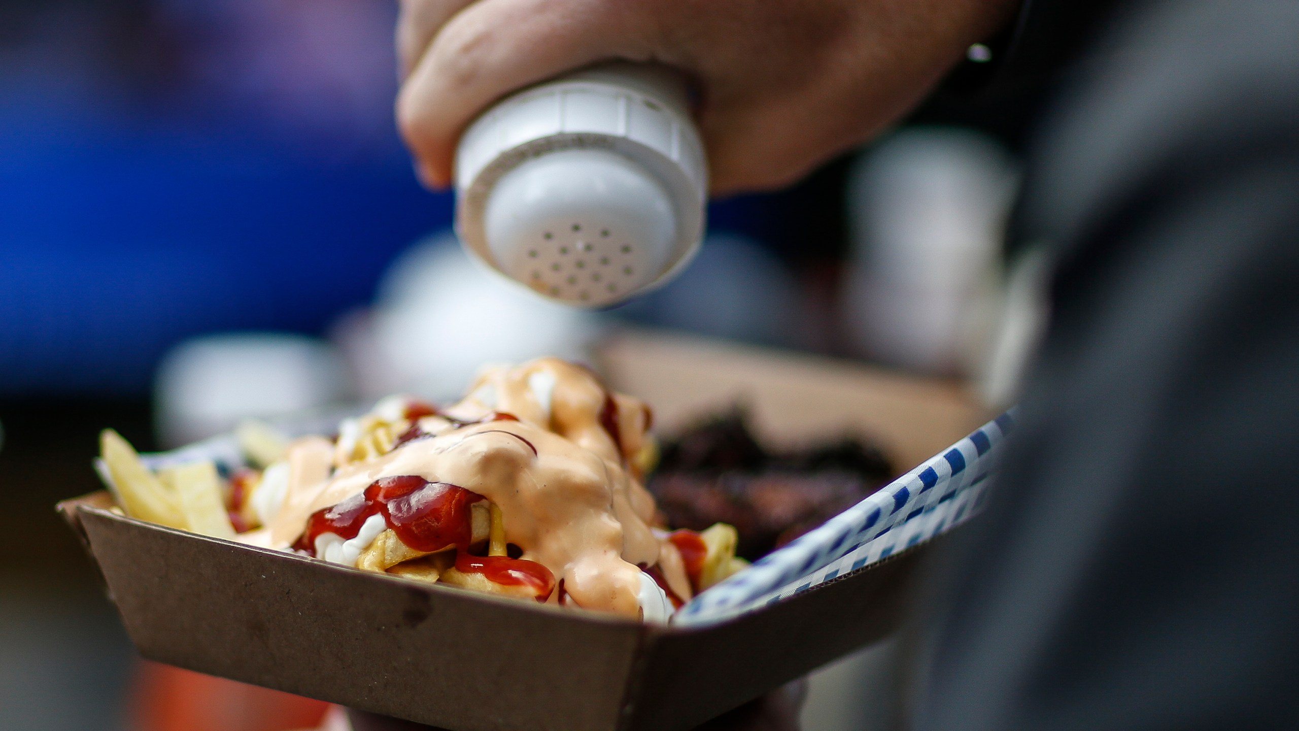 A fan enjoys food before kick off during the NFL match between the Arizona Cardinals and the Los Angeles Rams at Twickenham Stadium on Oct. 22, 2017. (Alan Crowhurst/Getty Images)