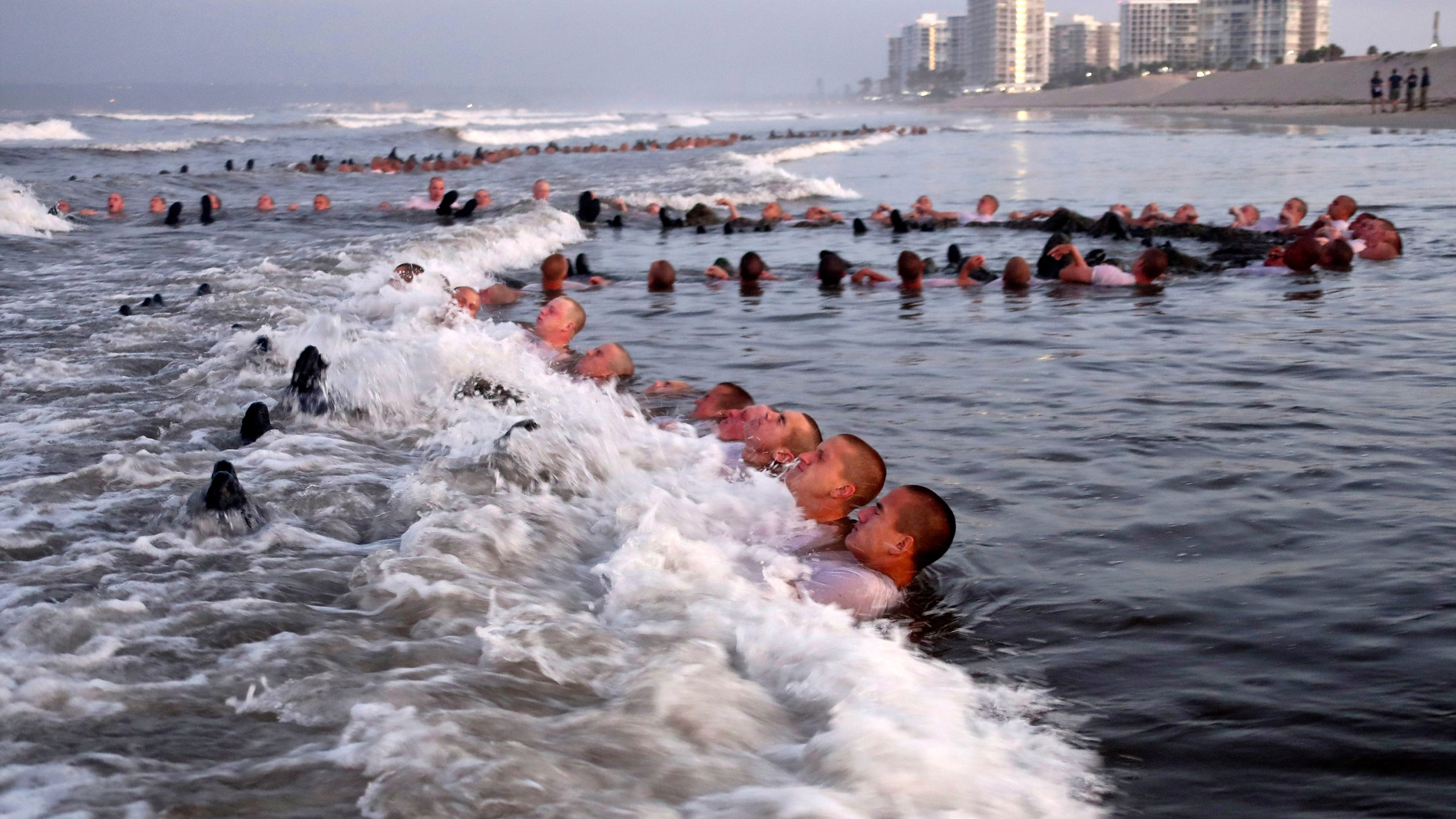 U.S. Navy SEAL candidates, participate in "surf immersion" during Basic Underwater Demolition/SEAL (BUD/S) training at the Naval Special Warfare (NSW) Center in Coronado, Calif., on May 4, 2020. A Navy SEAL candidate who died just hours after completing the grueling Hell Week test was identified Sunday, Feb. 6, 2022, as a 24-year-old sailor who joined the military last year. The U.S. Navy said that Seaman Kyle Mullen died at a San Diego area hospital on Friday, Feb. 4, after he and another SEAL trainee reported experiencing symptoms of an unknown illness. (MC1 Anthony Walker/U.S. Navy via AP, File)