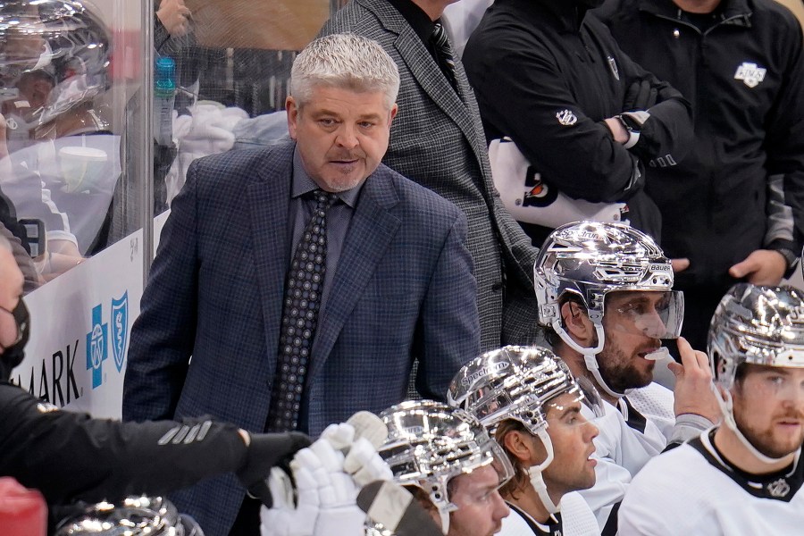 Los Angeles Kings head coach Todd McLellan, left, stands behind his bench during the third period of an NHL hockey game against the Pittsburgh Penguins in Pittsburgh, Sunday, Jan. 30, 2022. (AP Photo/Gene J. Puskar)