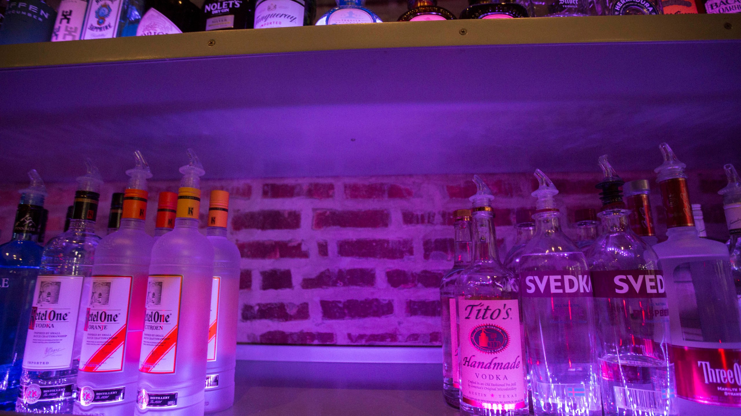 An empty space on a liquor shelf where Russian vodka used to be located at The Sidetrack, a gay bar on the north side of Chicago, July 29, 2013. The United States and Europe are slapping official sanctions on Russian banks and tech companies.  But bars and liquor stores across America and Canada have found another way to punish Russia for invading Ukraine: They’re pulling Russian vodka off their shelves and promoting Ukrainian brands instead. (AP Photo/Scott Eisen)