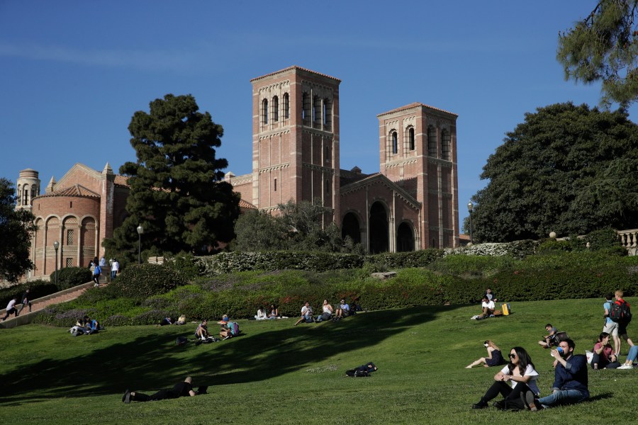 Students sit on the lawn near Royce Hall at the University of California, Los Angeles, in the Westwood section of Los Angeles on April 25, 2019. Matthew Harris, a former lecturer at UCLA, was arrested last week in Colorado after he allegedly emailed an 800-page document and posted videos threatening violence against dozens of people at the university. A trail of red flags about his behavior toward women followed Harris on an academic journey that took him to three of the nation’s most prestigious universities — Duke, Cornell and then the University of California, Los Angeles. (AP Photo/Jae C. Hong, File)