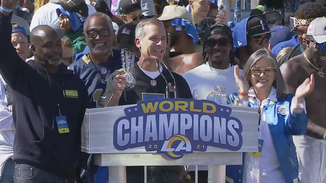 Los Angeles Mayor Eric Garcetti holds up keys to the city presented to three Rams players during the team's victory celebration on Feb. 16, 2022. (Pool)