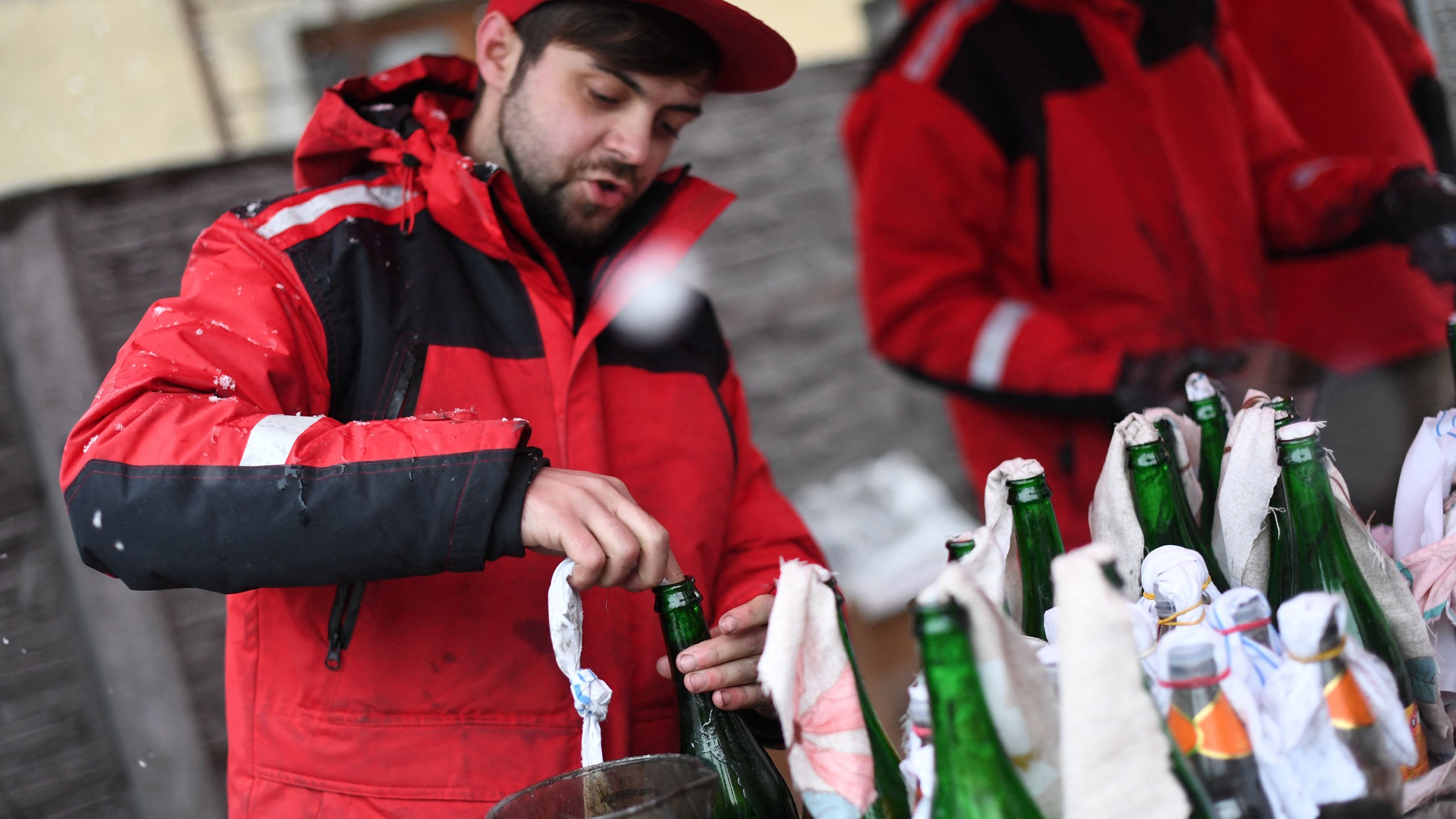 A volunteer demonstrates the preparation of Molotov cocktails at the Pravda - (Truth) brewery in Lviv on February 27, 2002. (DANIEL LEAL/AFP via Getty Images)