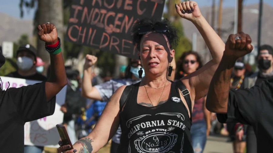 Denise Maupin and other community members protest outside John W. North High School in Riverside on Oct. 21 after a viral video showed a math teacher wearing a faux headdress and mimicking Native Americans during class.(Irfan Khan / Los Angeles Times)