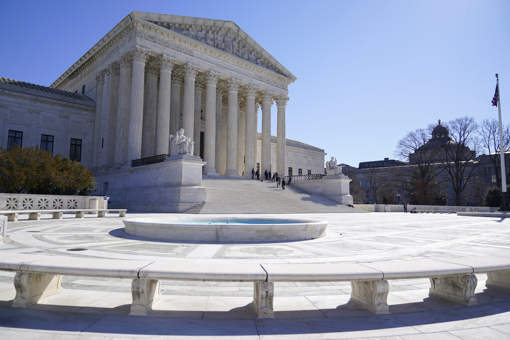 People stand on the steps of the U.S. Supreme Court, Feb.11, 2022, in Washington. (AP Photo/Mariam Zuhaib, File)