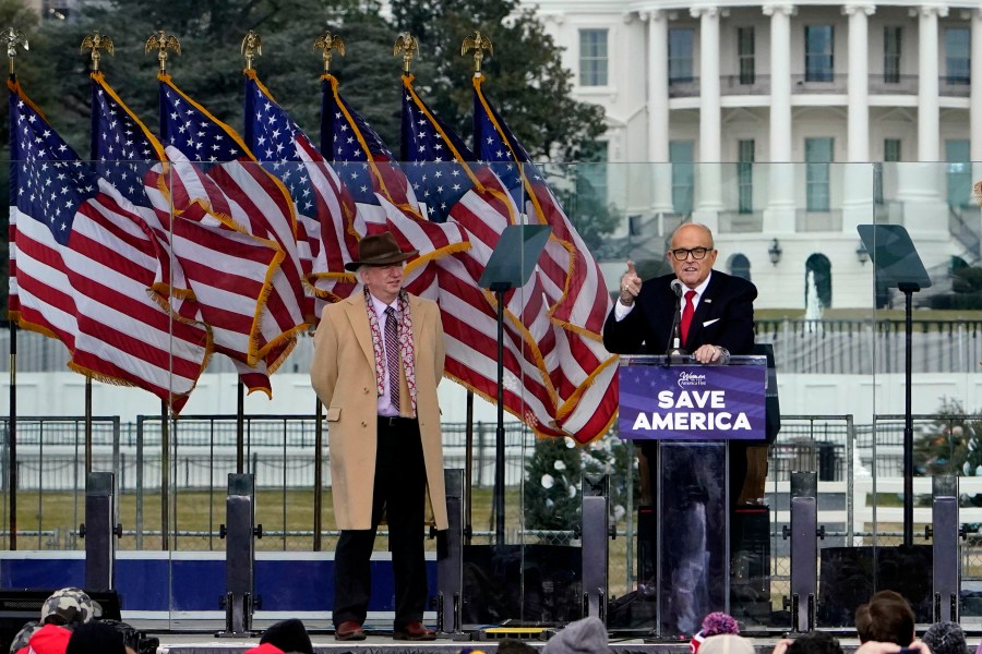 Chapman University law professor John Eastman stands at left as former New York Mayor Rudolph Giuliani speaks in Washington at a rally in support of President Donald Trump, called the "Save America Rally" on Jan. 6, 2021. (Jacquelyn Martin/Associated Press)