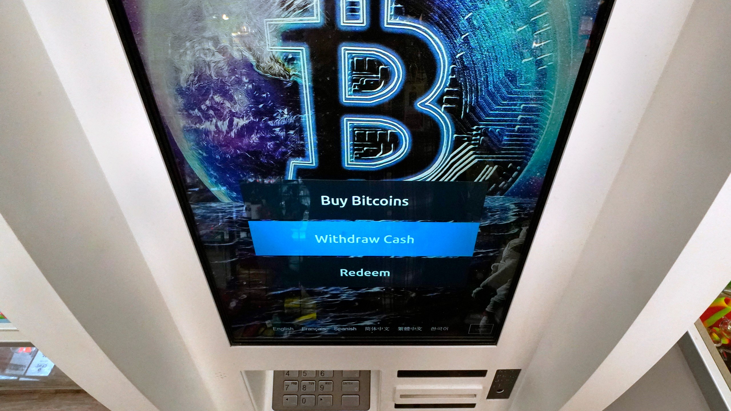 In this Feb. 9, 2021, photo, the Bitcoin logo appears on the display screen of a cryptocurrency ATM at the Smoker's Choice store in Salem, N.H. (Charles Krupa)