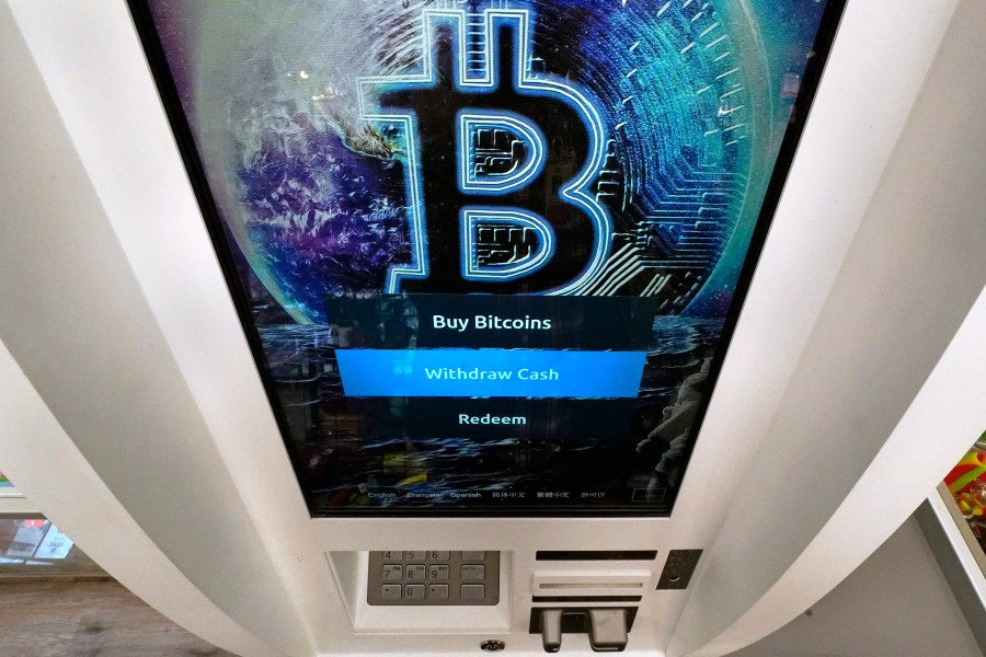 In this Feb. 9, 2021, photo, the Bitcoin logo appears on the display screen of a cryptocurrency ATM at the Smoker's Choice store in Salem, N.H. (Charles Krupa)