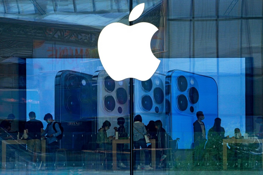 People shop at an Apple Store in Beijing, on Sept. 28, 2021. (AP Photo/Andy Wong, File)