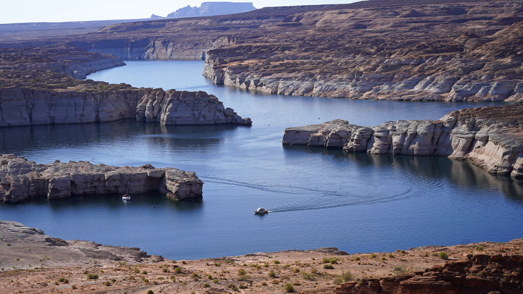 In this July 31, 2021 photo, a boat cruises along Lake Powell near Page, Ariz. (AP Photo/Rick Bowmer, File)