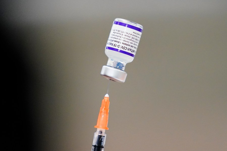 A syringe is prepared with the Pfizer COVID-19 vaccine at a vaccination clinic at the Keystone First Wellness Center in Chester, Pa., on Dec. 15, 2021. Pfizer is expected to request authorization for an additional COVID-19 booster dose for seniors. (AP Photo/Matt Rourke, File)