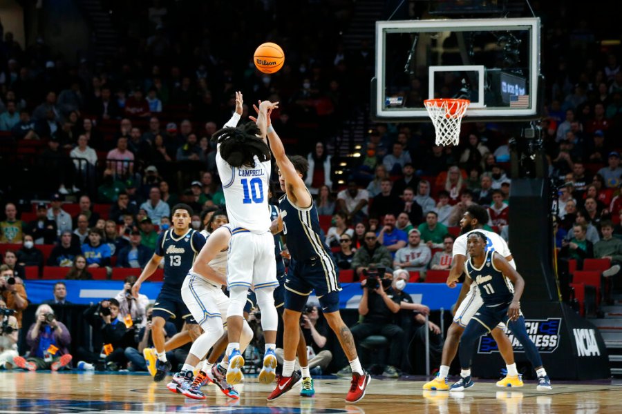 UCLA guard Tyger Campbell (10) shoots a three-pointer against Akron during the second half of a first-round NCAA college basketball tournament game, Thursday, March 17, 2022, in Portland, Ore. (AP Photo/Craig Mitchelldyer)