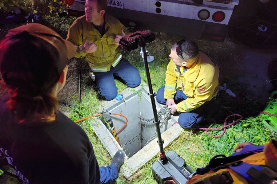 In this image provided by the Contra Costa County Fire Protection District, emergency personnel work on rescuing a man from an underground storm water pipe in Antioch, Calif., Sunday, March 20, 2022. (Steve Hill/Contra Costa County Fire Protection District via AP)