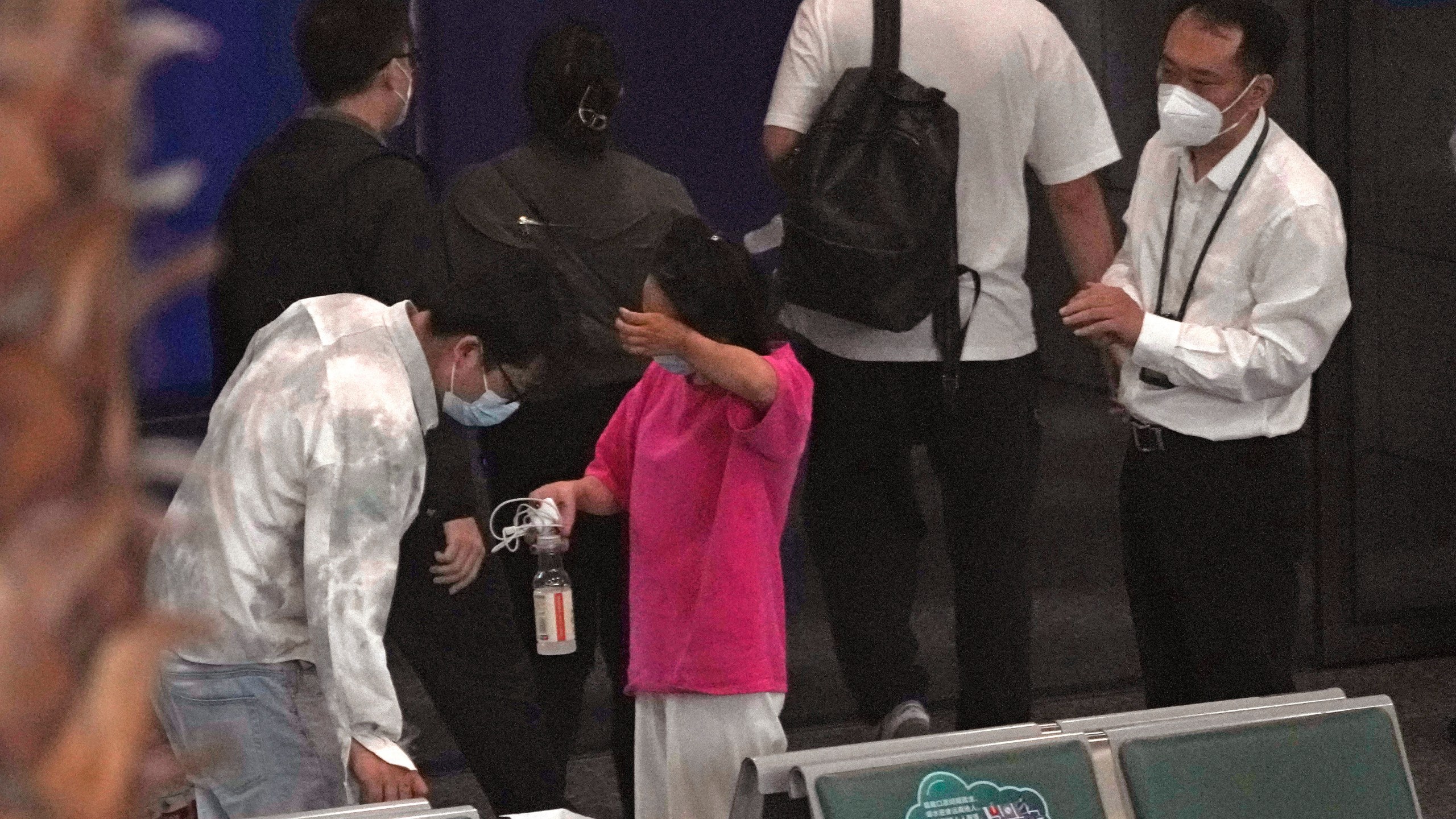 A woman reacts as she prepares to leave an area for relatives of the passengers aboard China Eastern's flight MU5735 at the Guangzhou Baiyun International Airport, Tuesday, March 22, 2022, in Guangzhou. No survivors have been found as rescuers on Tuesday searched the scattered wreckage of a China Eastern plane carrying 132 people that crashed a day earlier on a wooded mountainside in China's worst air disaster in more than a decade. (AP Photo/Ng Han Guan)