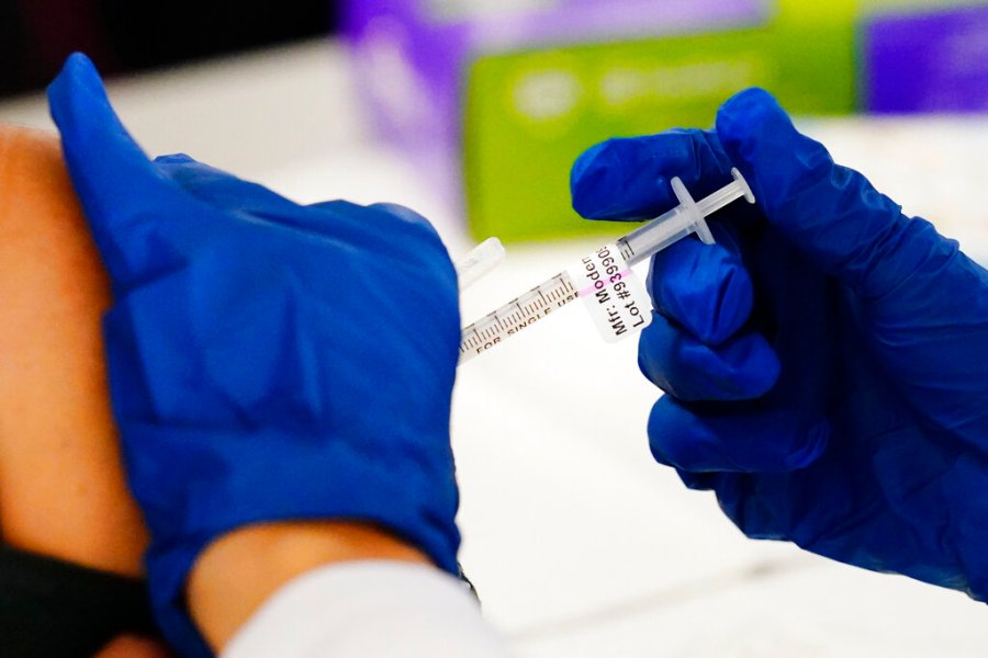 A health worker administers a dose of a Moderna COVID-19 vaccine during a vaccination clinic at the Norristown Public Health Center in Norristown, Pa., Tuesday, Dec. 7, 2021. (AP Photo/Matt Rourke, File)