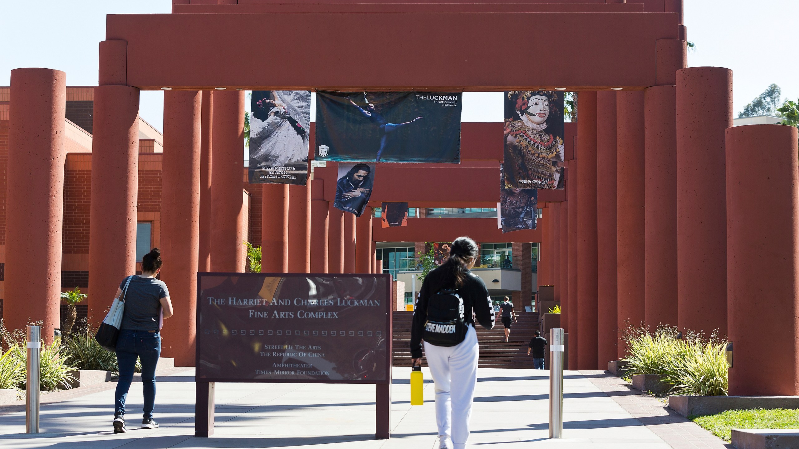 Students walk past the Harriet and Charles Luckman Fine Arts Complex at the Cal State University, Los Angeles campus on April 25, 2019. (AP Photo/Damian Dovarganes, File)