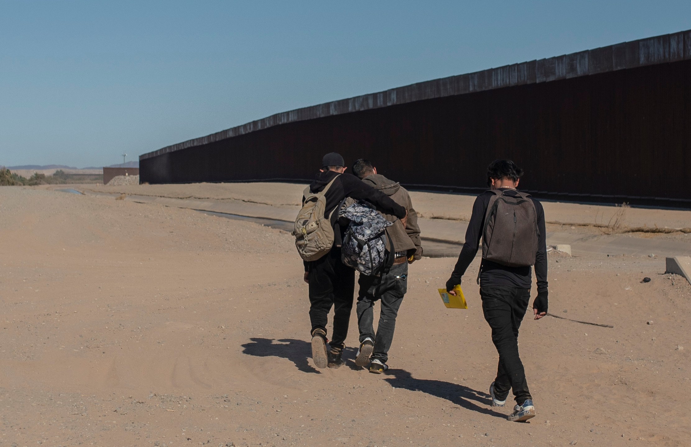 Nicaraguan migrants walk on the U.S.-Mexico border, in Algodones, Baja California, Mexico, on Dec. 2, 2021. The group walked into the U.S. and turned themselves over to the border patrol asking for asylum. (AP Photo/Felix Marquez, File)