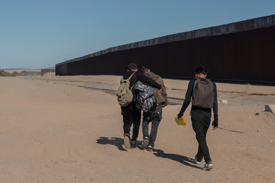 Nicaraguan migrants walk on the U.S.-Mexico border, in Algodones, Baja California, Mexico, on Dec. 2, 2021. The group walked into the U.S. and turned themselves over to the border patrol asking for asylum. (AP Photo/Felix Marquez, File)