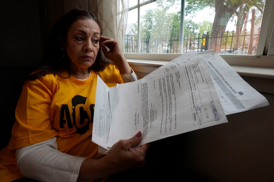 Carmen Rivera 54, displays some of the eviction notices she has received for her tiny apartment in Sacramento, Calif., Wednesday, March 30, 2022. A bill approved by the legislature on Thursday, March 31 2022, will stop people from being evicted from their homes through June 30 as long as they have applied for state assistance. Rivera has a pending application and is waiting to hear if she has been approved. Thursday is the last day to apply for assistance. (AP Photo/Rich Pedroncelli)