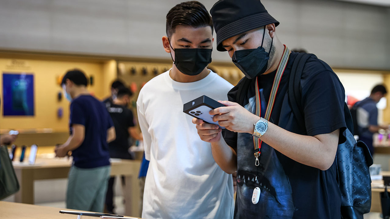 Apple's latest iOS update allows users to unlock their phones, use Apple Pay or open passcode-protected apps while wearing a mask. (Feline Lim/Getty Images)