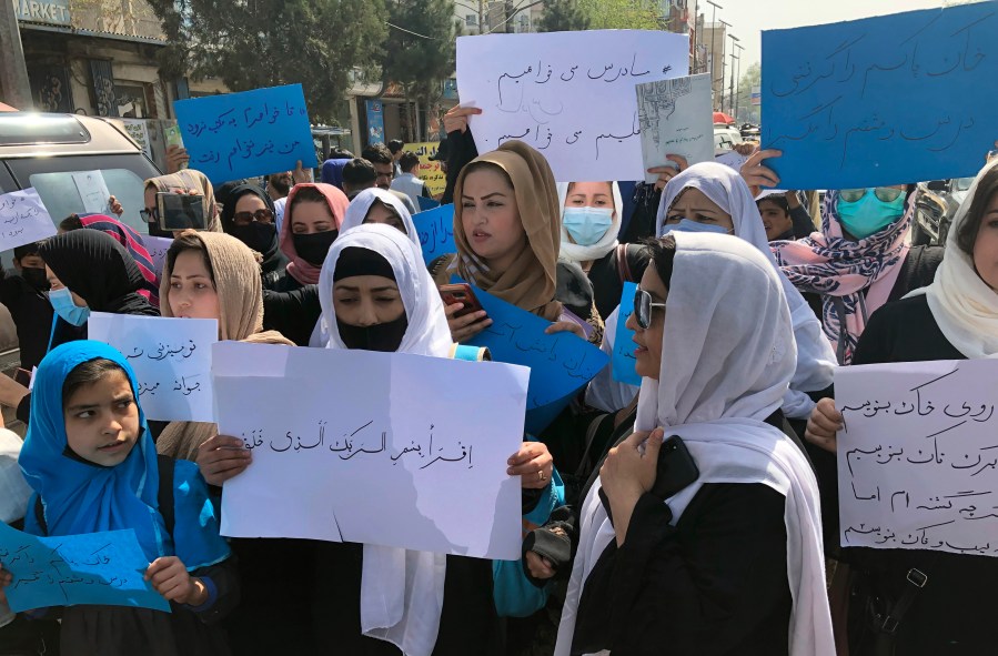 Afghan women chant and hold signs of protest during a demonstration in Kabul, Afghanistan, Saturday, March 26, 2022. Afghanistan's Taliban rulers refused to allow dozens of women to board several flights, including some overseas, because they were traveling without a male guardian, two Afghan airline officials said Saturday. (AP Photo/Mohammed Shoaib Amin)