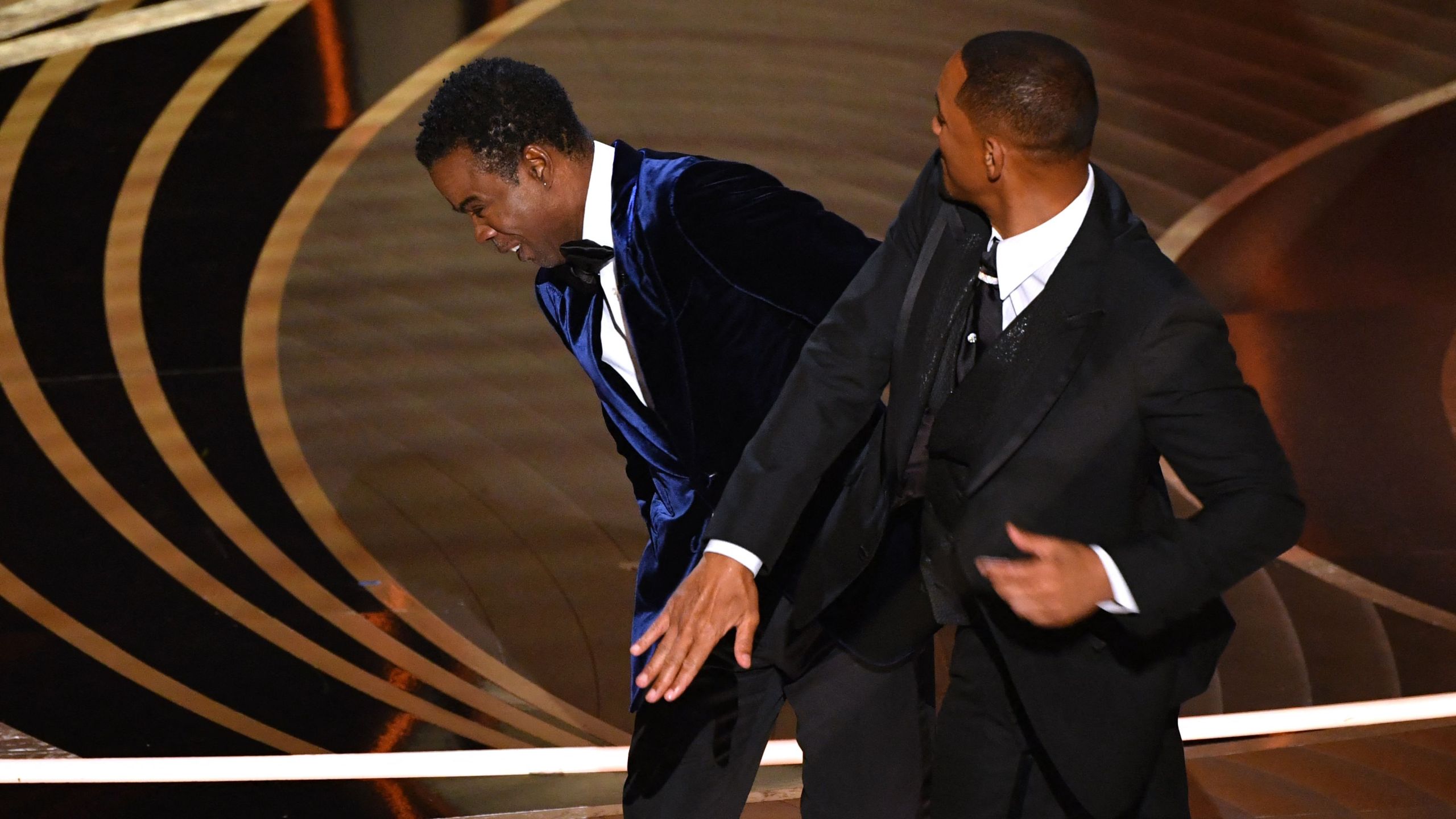 Actor Will Smith, right, slaps actor Chris Rock onstage during the 94th Oscars at the Dolby Theatre in Hollywood, California on March 27, 2022. (Robyn Beck / AFP via Getty Images)