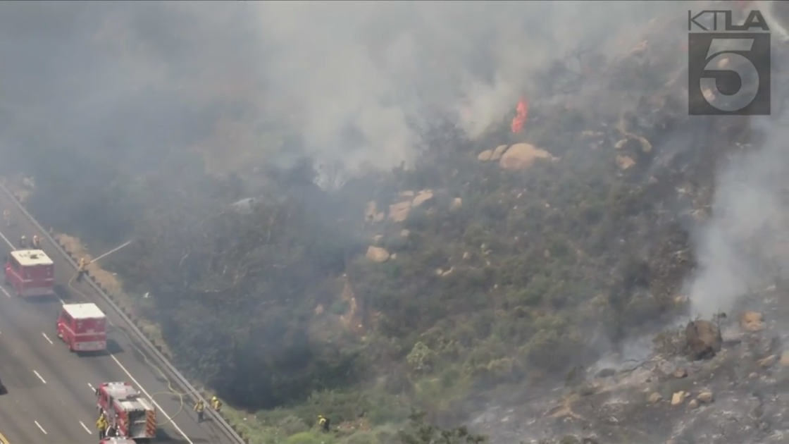 Crews battle a brush fire in Chatsworth on April 6, 2022. (KTLA)