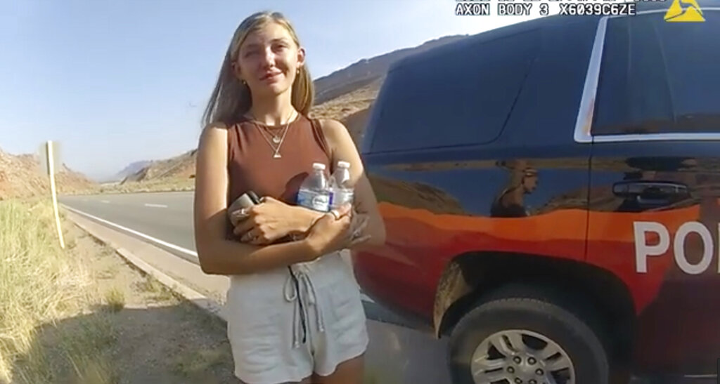 This police camera video provided by The Moab Police Department shows Gabrielle "Gabby" Petito talking to a police officer after police pulled over the van she was traveling in with her boyfriend, Brian Laundrie, near the entrance to Arches National Park on Aug. 12, 2021. (The Moab Police Department via AP)