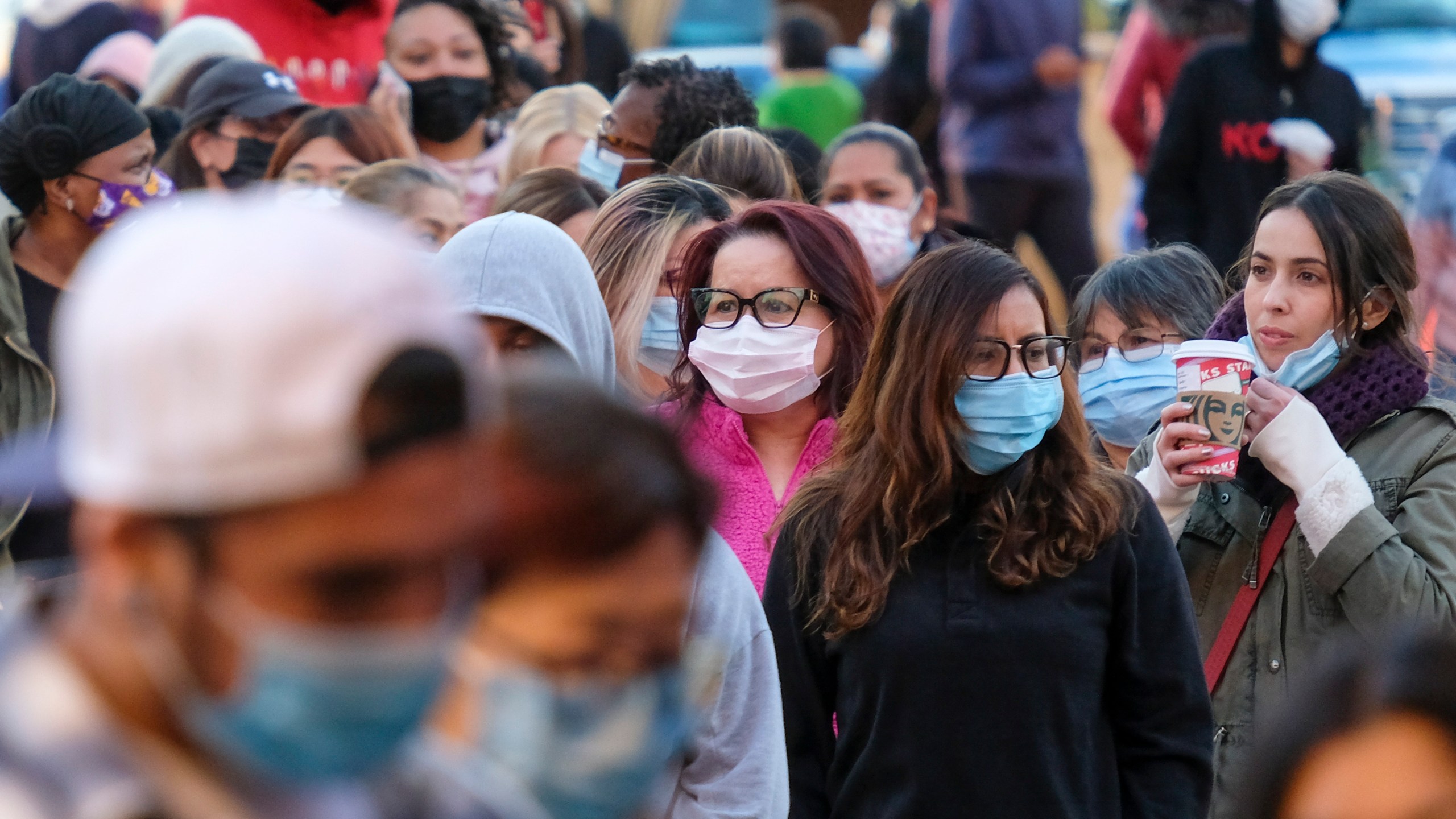 Shoppers wait in line to enter a store at the Citadel Outlets in Commerce on Friday, Nov. 26, 2021. (AP Photo/Ringo H.W. Chiu, File)