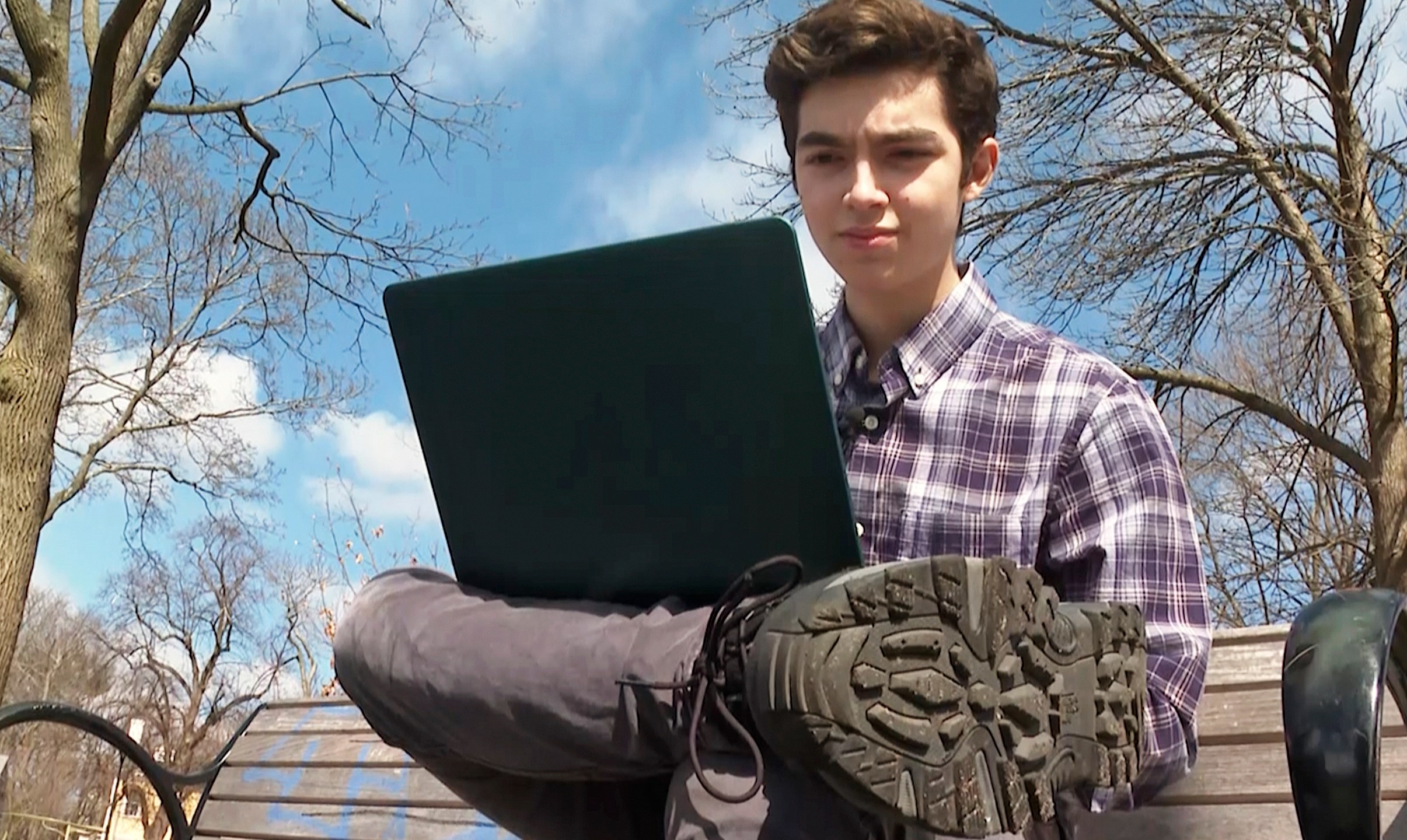 Harvard freshman Marco Burstein, 18, of Los Angeles, works on his computer near the campus of Harvard University in Cambridge, Mass., March 16, 2022. (AP Photo/Rodrique Ngowi)