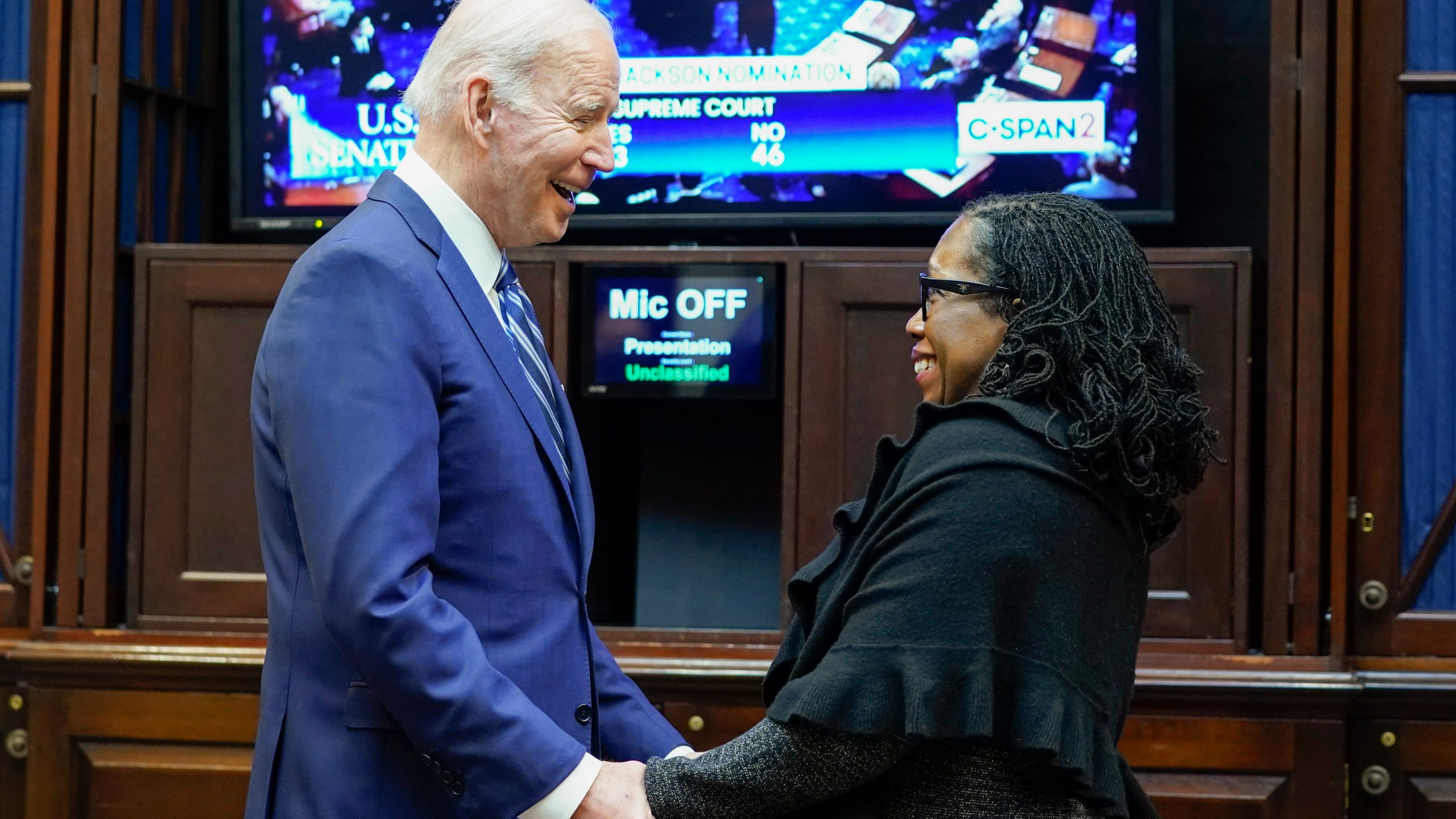 President Joe Biden holds hands with Supreme Court nominee Judge Ketanji Brown Jackson as they watch the Senate vote on her confirmation from the Roosevelt Room of the White House on April 7, 2022. (Susan Walsh/Associated Press)