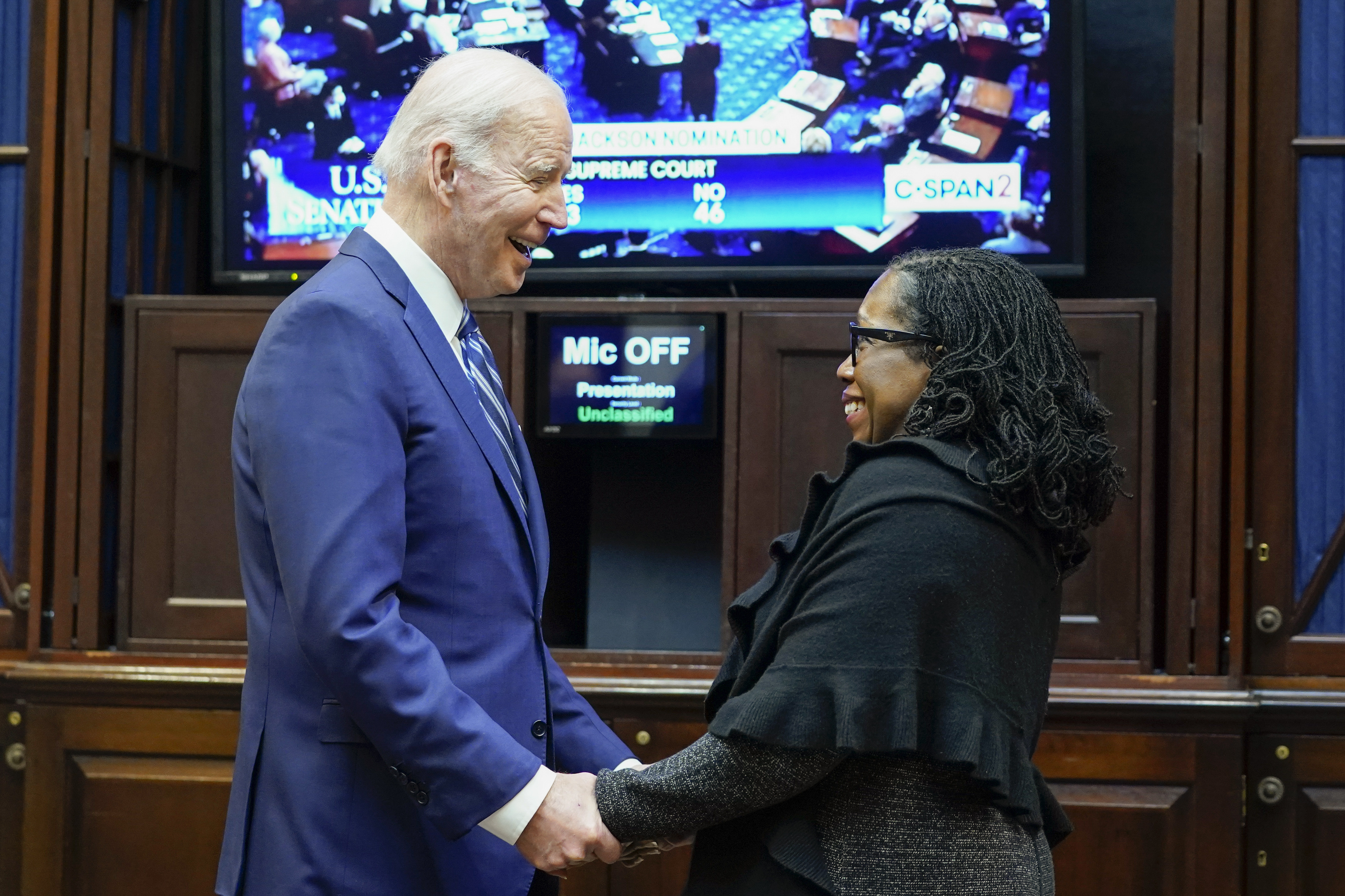 President Joe Biden holds hands with Supreme Court nominee Judge Ketanji Brown Jackson as they watch the Senate vote on her confirmation from the Roosevelt Room of the White House on April 7, 2022. (Susan Walsh/Associated Press)