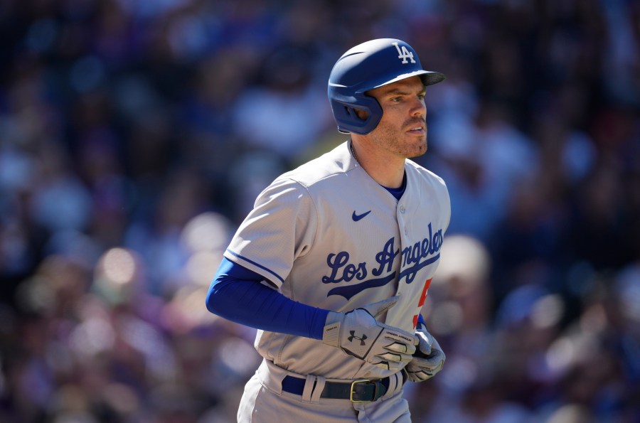 Los Angeles Dodgers' Freddie Freeman heads to first base after getting hit in the back by a pitch from Colorado Rockies starting pitcher Kyle Freeland in the third inning of a baseball game in Denver on April 8, 2022. (David Zalubowski/Associated Press)