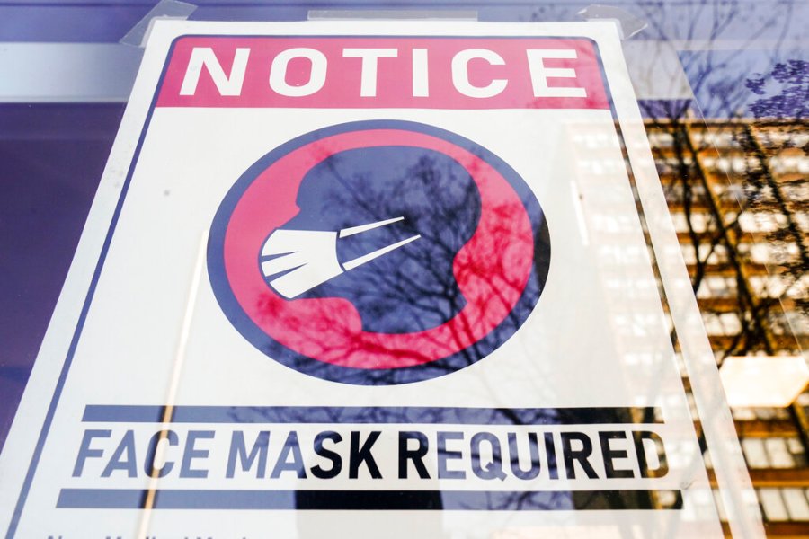 A sign requiring masks as a precaution against the spread of the coronavirus on a store front in Philadelphia, is seen Feb. 16, 2022. (AP Photo/Matt Rourke, File)