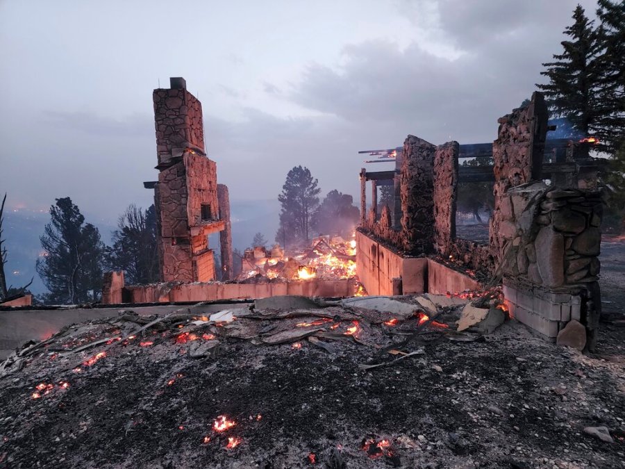 The remains of a home left after a wildfire spread through the Village of Ruidoso, New Mexico, on Wednesday, April 13, 2022. (Alexander Meditz via AP)