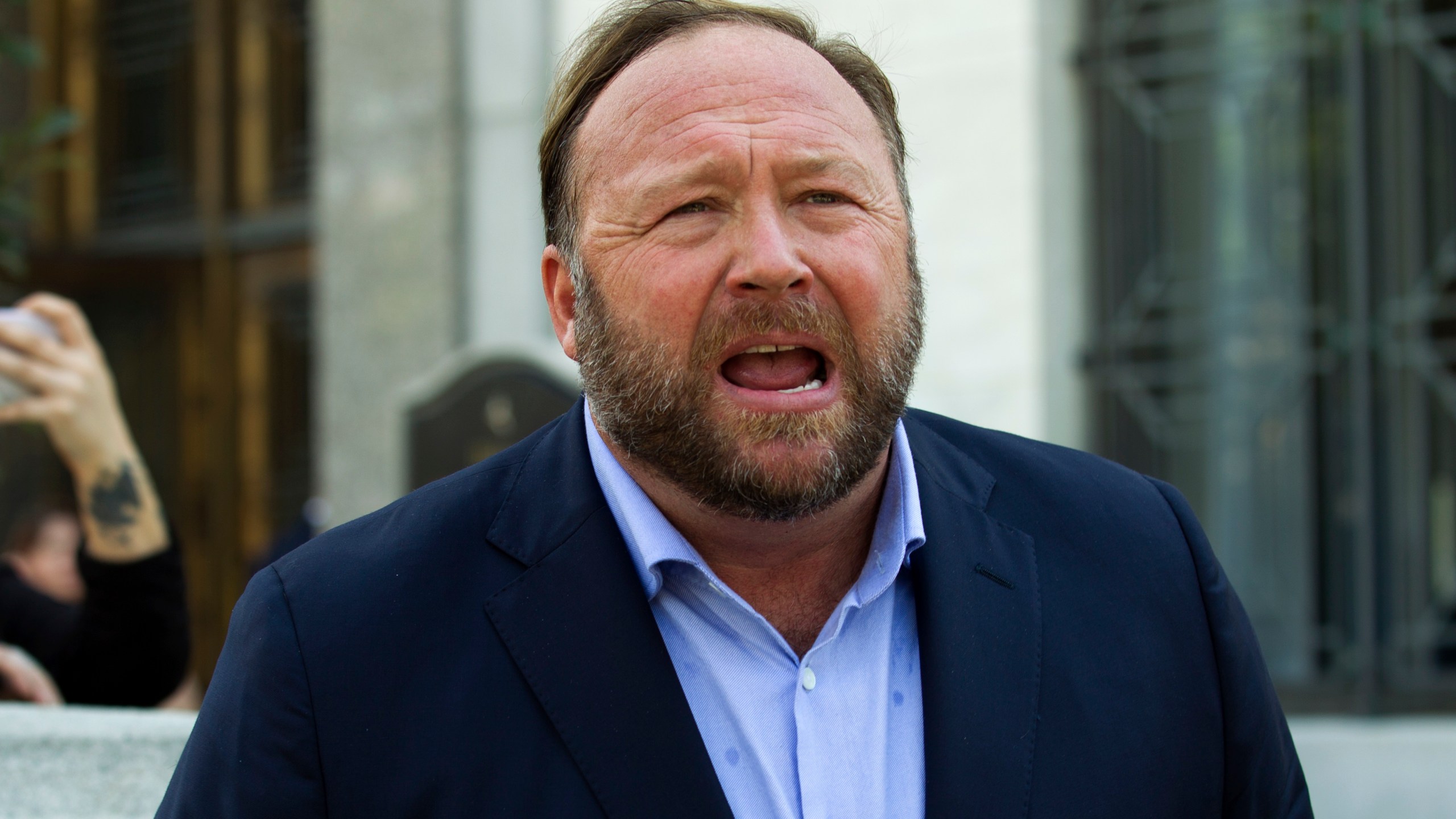 Alex Jones speaks to reporters in Washington on Sept. 5, 2018. Infowars filed for Chapter 11 bankruptcy protection on April 17, 2022, in Texas as its founder and conspiracy theorist Alex Jones faces defamation lawsuits over his comments that the Sandy Hook Elementary School shooting was a hoax. (Jose Luis Magana/Associated Press)