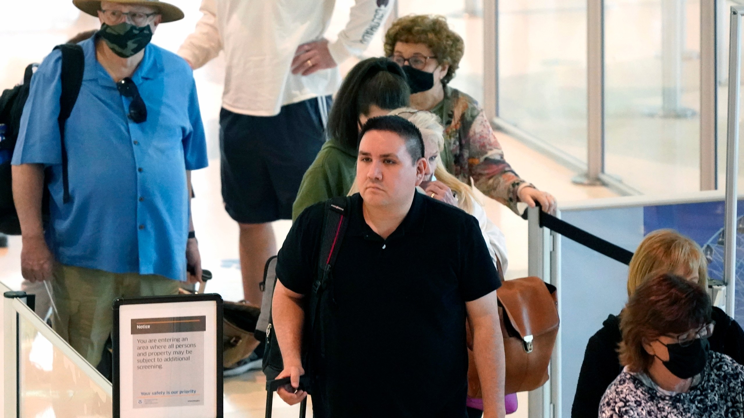 Travelers wait in a security line at Love Field in Dallas, Tuesday, April 19, 2022. (AP Photo/LM Otero)