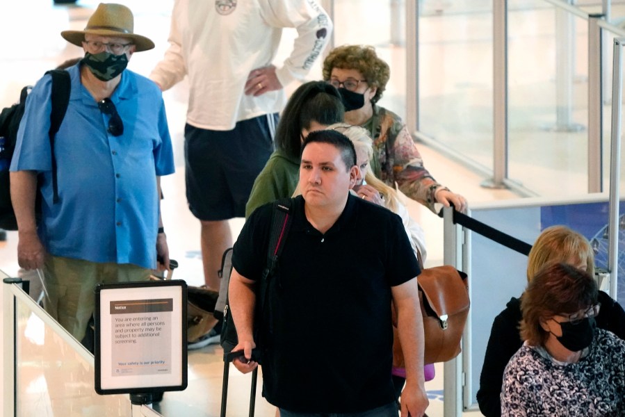 Travelers wait in a security line at Love Field in Dallas, Tuesday, April 19, 2022. (AP Photo/LM Otero)