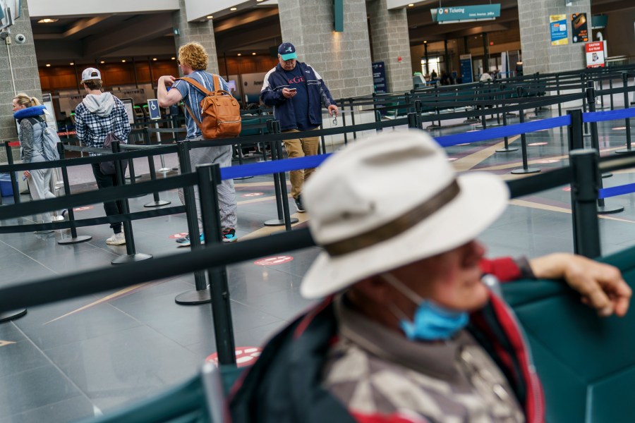 Travelers enter a security line at Rhode Island T.F. Green International Airport in Providence, R.I. on April 19, 2022. (David Goldman/Associated Press)