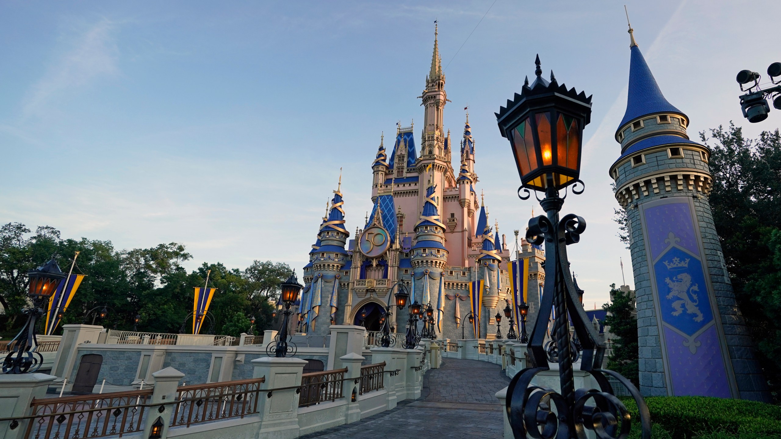 The newly painted Cinderella Castle at the Magic Kingdom at Walt Disney World is seen with the the crest to celebrate the 50th anniversary of the theme park Monday, Aug. 30, 2021, in Lake Buena Vista, Fla. (AP Photo/John Raoux, File)