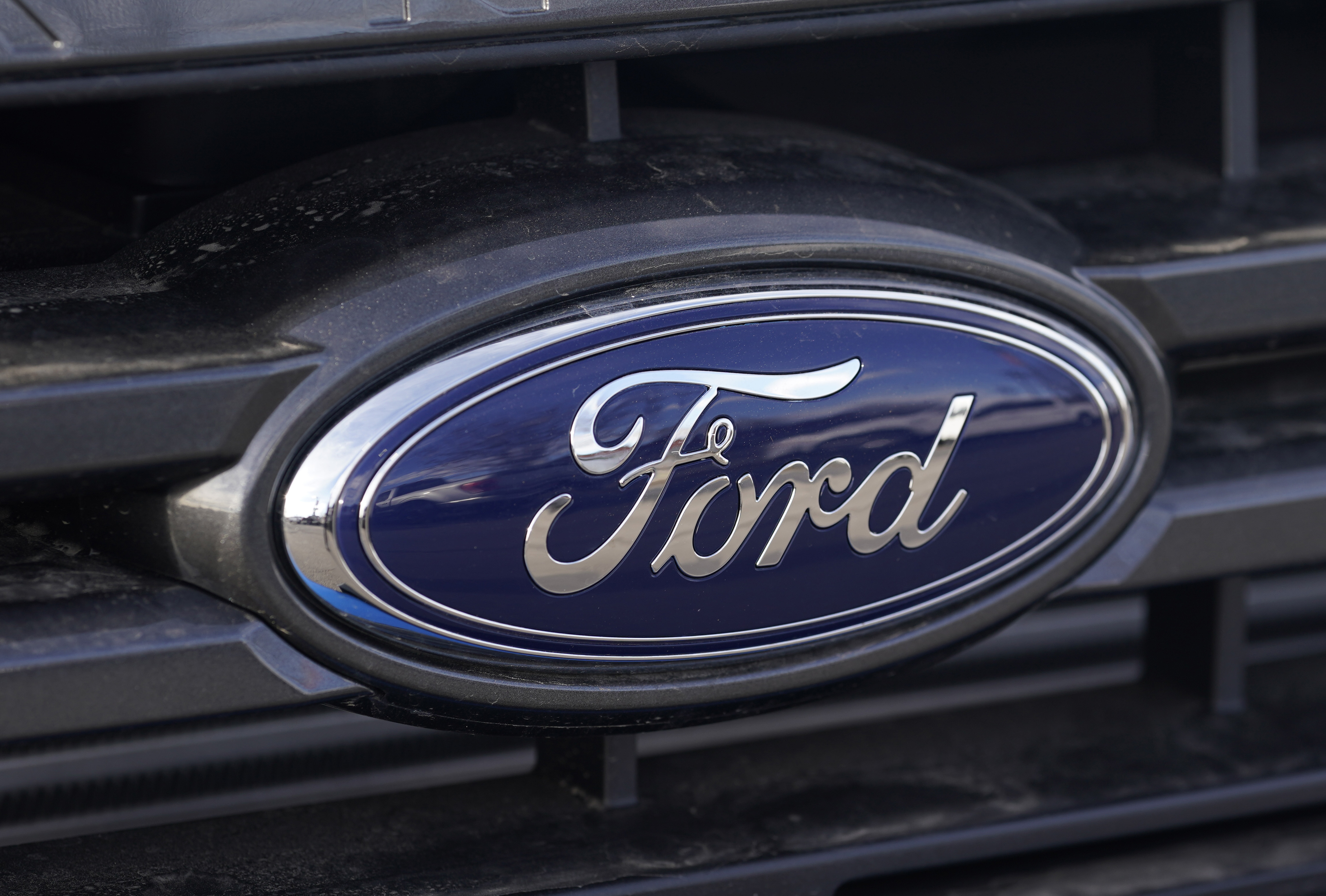 In this Sunday, April 25, 2021, photograph, the blue oval logo of Ford Motor Company is shown at a dealership in east Denver. (AP Photo/David Zalubowski, File)