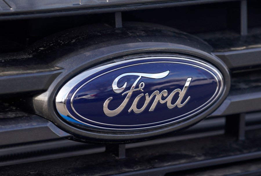 In this Sunday, April 25, 2021, photograph, the blue oval logo of Ford Motor Company is shown at a dealership in east Denver. (AP Photo/David Zalubowski, File)