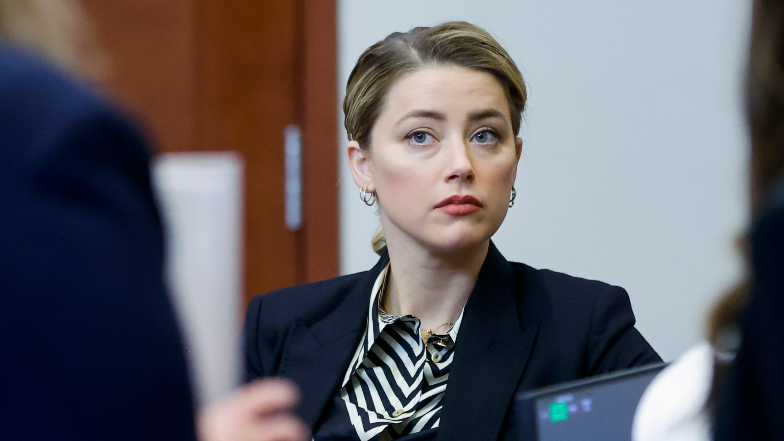 Actor Amber Heard appears in the courtroom at the Fairfax County Circuit Court in Fairfax, Va., Wednesday, April 27, 2022. Actor Johnny Depp sued his ex-wife actress Amber Heard for libel in Fairfax County Circuit Court after she wrote an op-ed piece in The Washington Post in 2018 referring to herself as a "public figure representing domestic abuse." (Jonathan Ernst/Pool Photo via AP)