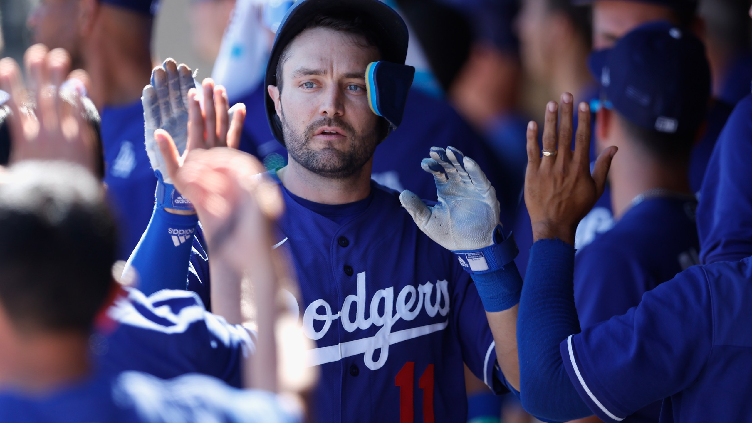 AJ Pollock high fives teammates in the dugout after hitting a solo home run against the Colorado Rockies during the third inning of the MLB spring training game at Salt River Fields at Talking Stick on March 24, 2022 in Scottsdale, Arizona. (Christian Petersen/Getty Images)