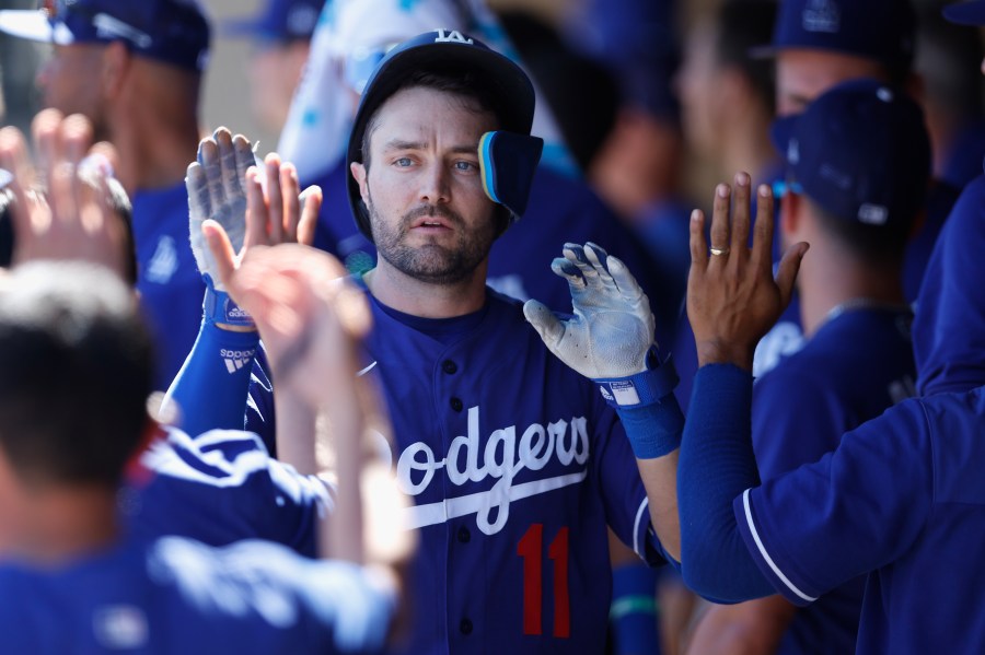 AJ Pollock high fives teammates in the dugout after hitting a solo home run against the Colorado Rockies during the third inning of the MLB spring training game at Salt River Fields at Talking Stick on March 24, 2022 in Scottsdale, Arizona. (Christian Petersen/Getty Images)