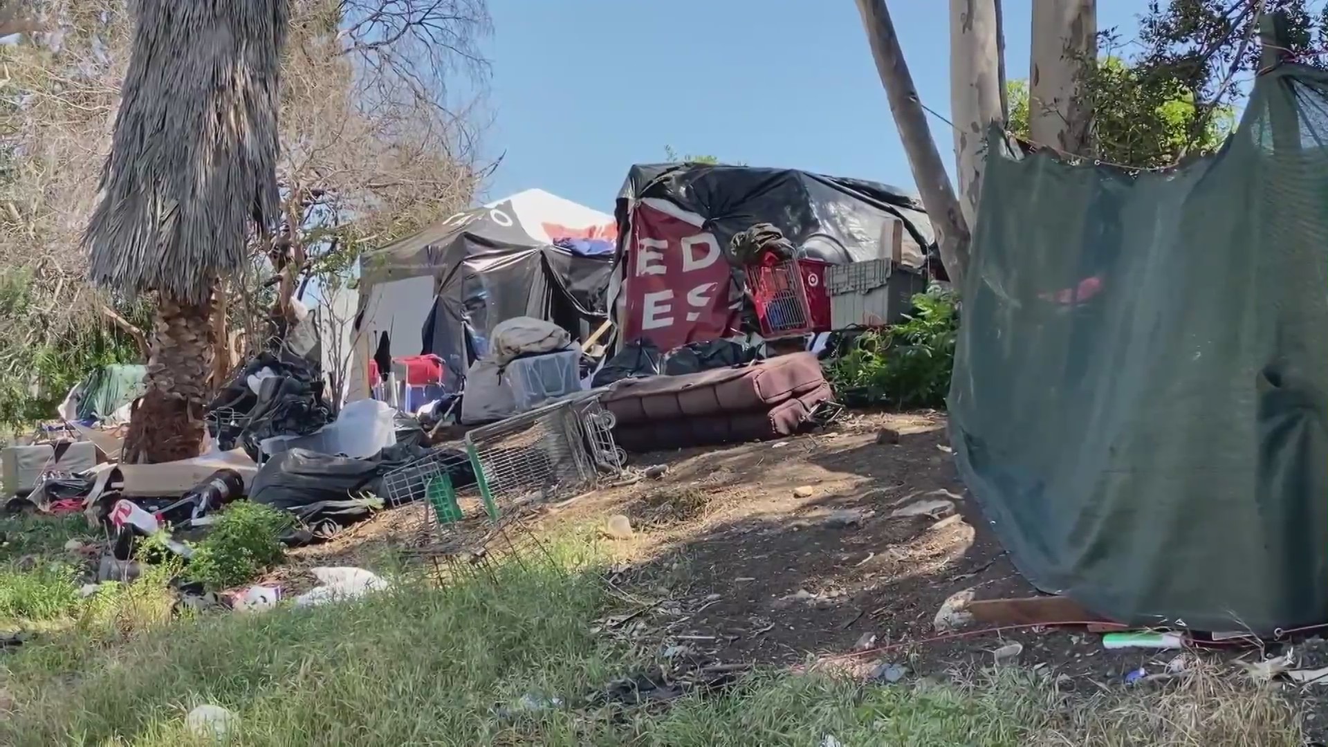 A state bill aims to reduce the number of homeless encampments in and near rivers, like this one on April 15, 2022. (KTLA)